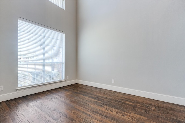 spare room with dark hardwood / wood-style floors