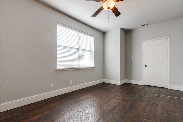 empty room featuring dark wood-type flooring and ceiling fan