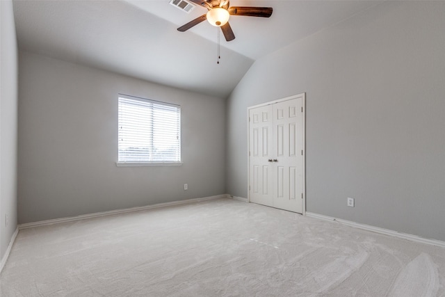 unfurnished bedroom with vaulted ceiling, ceiling fan, light carpet, and a closet