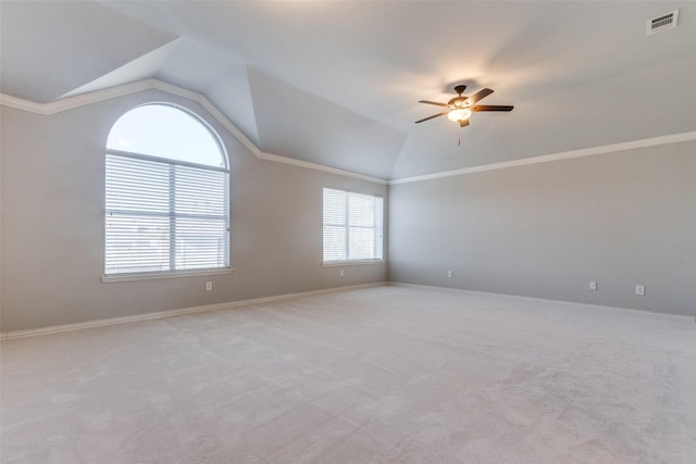 carpeted empty room with crown molding, ceiling fan, and lofted ceiling