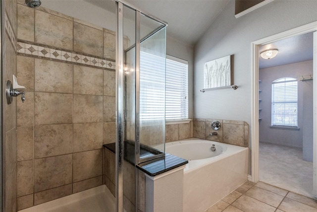 bathroom featuring vaulted ceiling, separate shower and tub, plenty of natural light, and tile patterned floors