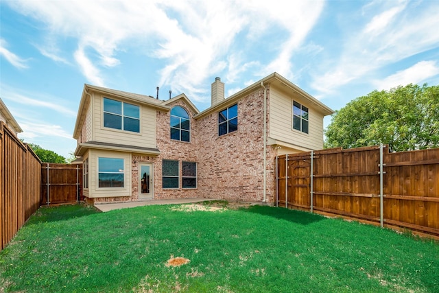 back of property with a patio and a lawn