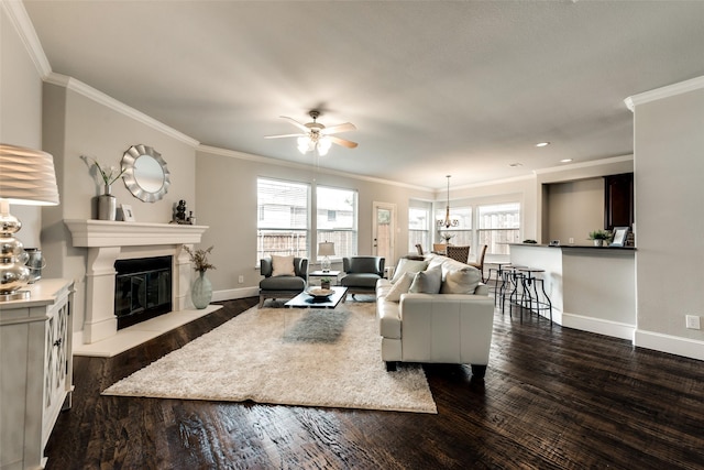 living room featuring ceiling fan, ornamental molding, plenty of natural light, and dark hardwood / wood-style floors