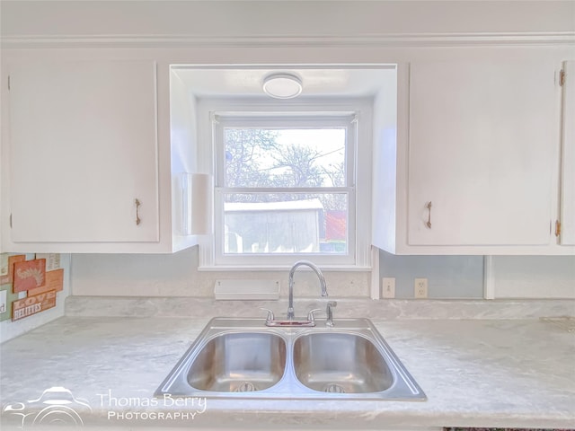 kitchen featuring white cabinetry and sink