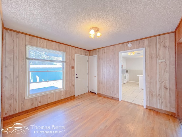 spare room featuring hardwood / wood-style flooring and wooden walls