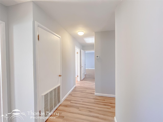 corridor with light wood-type flooring