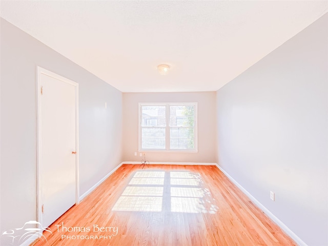 empty room with light hardwood / wood-style flooring