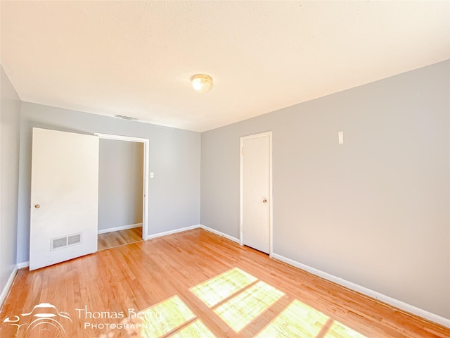 unfurnished room featuring hardwood / wood-style flooring