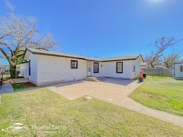 rear view of house featuring a yard, central AC, and a patio