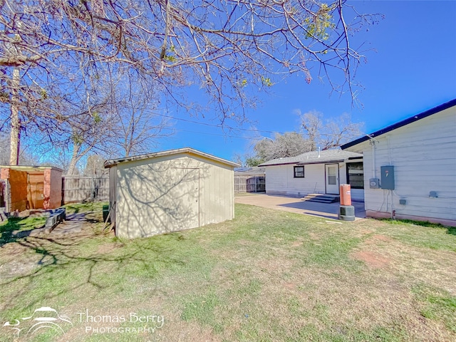 view of yard with a storage unit and a patio area