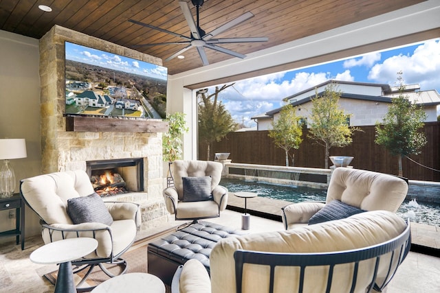 exterior space with ceiling fan and an outdoor stone fireplace