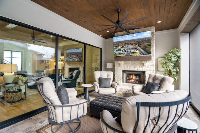 view of patio with ceiling fan and an outdoor stone fireplace