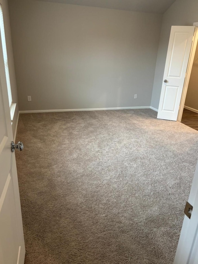 empty room with dark carpet