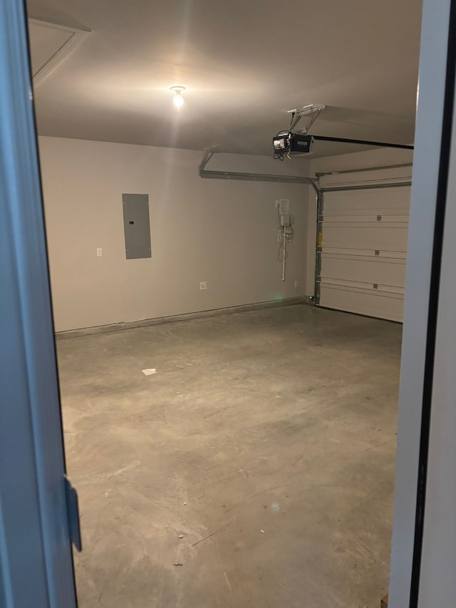 garage with a garage door opener and electric panel