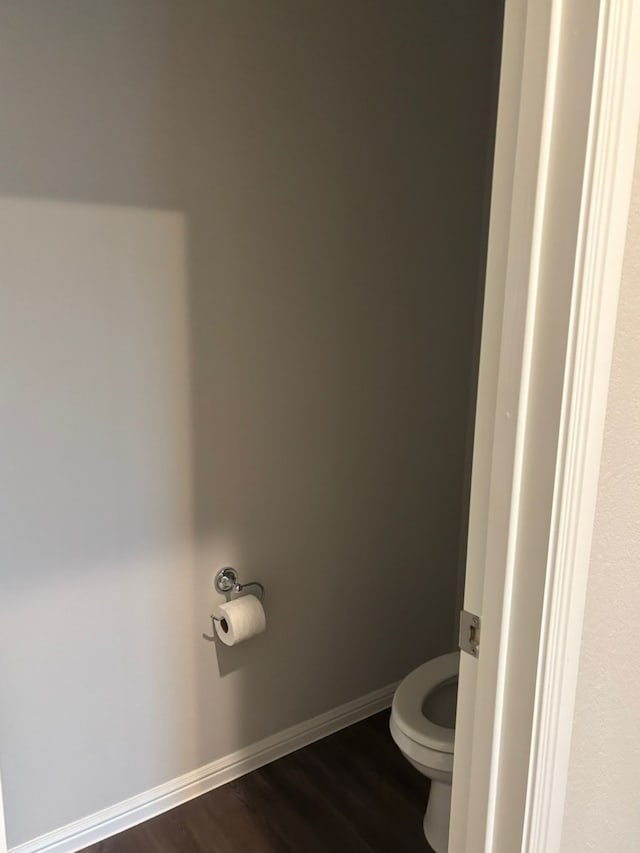 bathroom with hardwood / wood-style floors and toilet