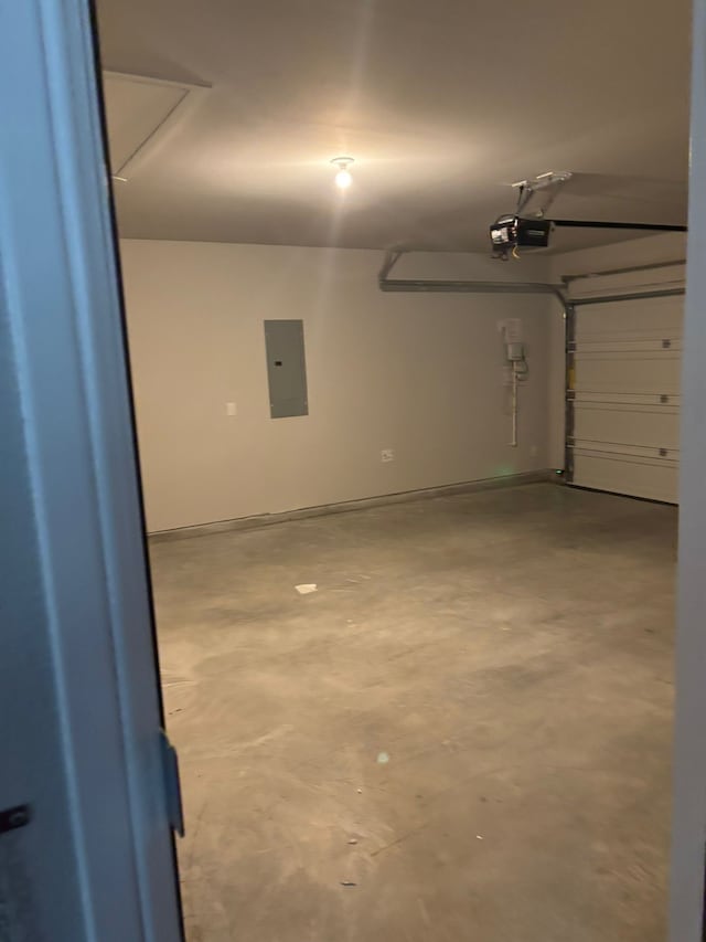 garage with a garage door opener and electric panel