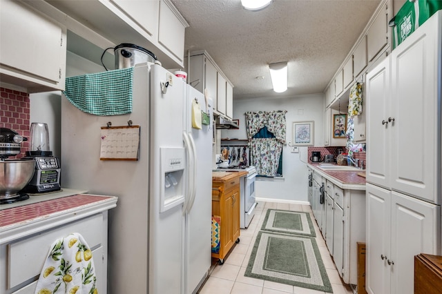 kitchen with white cabinetry, a textured ceiling, light tile patterned floors, white appliances, and decorative backsplash