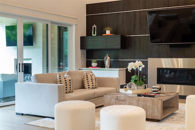 living room featuring light hardwood / wood-style flooring and a fireplace