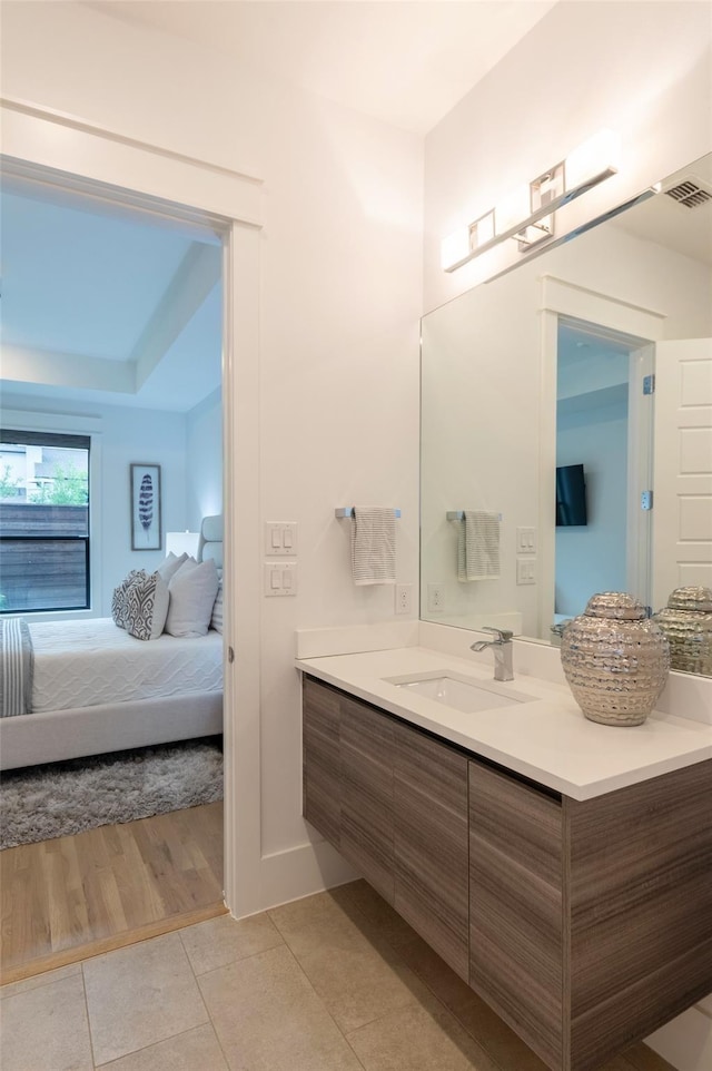 bathroom with tile patterned floors and vanity