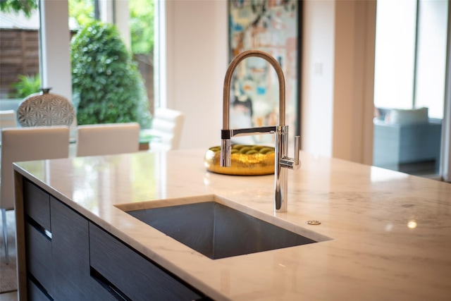 details with light stone countertops and sink