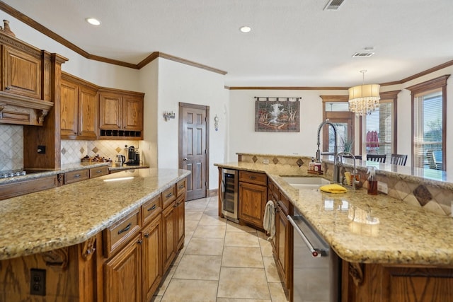 kitchen featuring dishwasher, hanging light fixtures, a kitchen island with sink, sink, and wine cooler