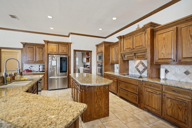 kitchen with sink, backsplash, a center island, and appliances with stainless steel finishes