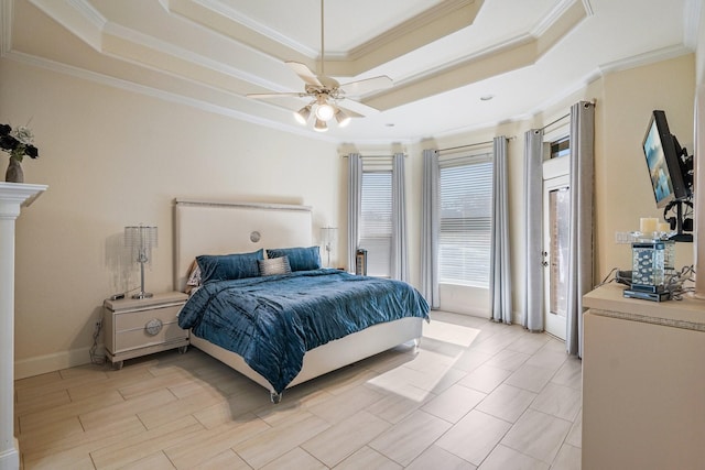 bedroom with ceiling fan, a tray ceiling, and crown molding