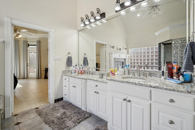 bathroom featuring vanity, ceiling fan, lofted ceiling, and tile patterned flooring