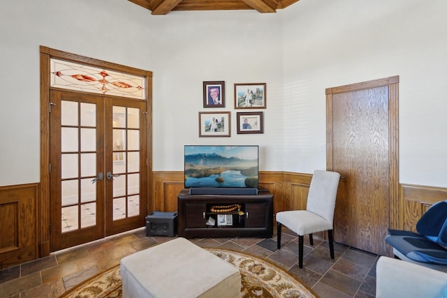 living area featuring beamed ceiling, french doors, and coffered ceiling