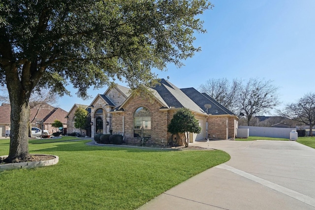 view of front of house with a front yard and a garage