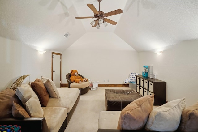 living room with carpet floors, a textured ceiling, lofted ceiling, and ceiling fan