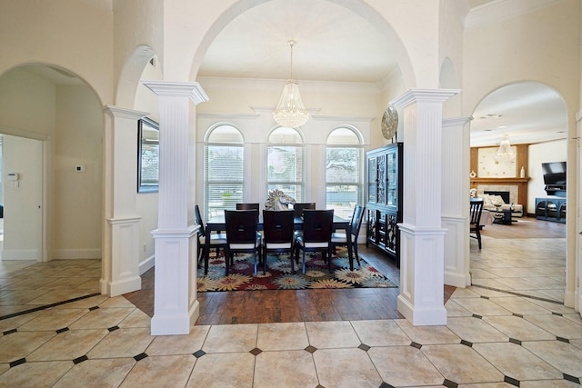 dining space featuring ornate columns and light tile patterned flooring