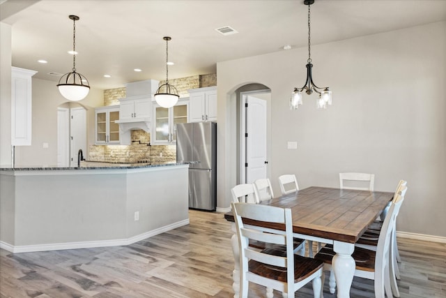 dining area featuring light wood-type flooring