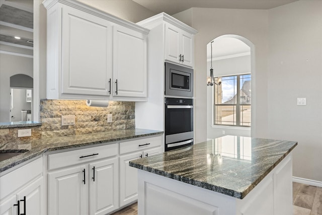 kitchen with white cabinets, dark stone countertops, and appliances with stainless steel finishes