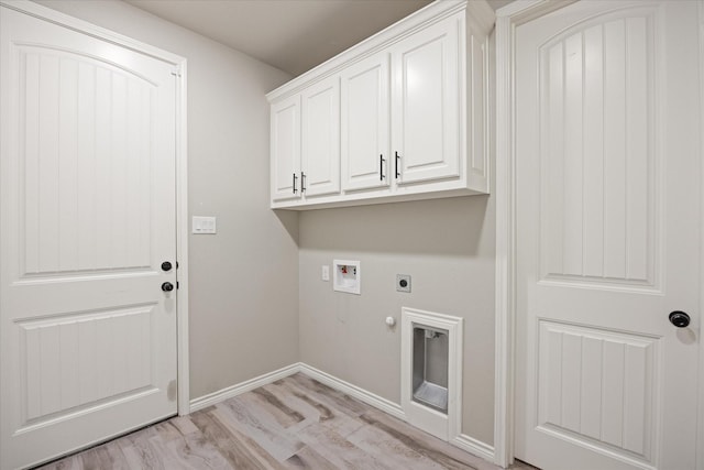 laundry room with electric dryer hookup, light hardwood / wood-style flooring, hookup for a washing machine, gas dryer hookup, and cabinets