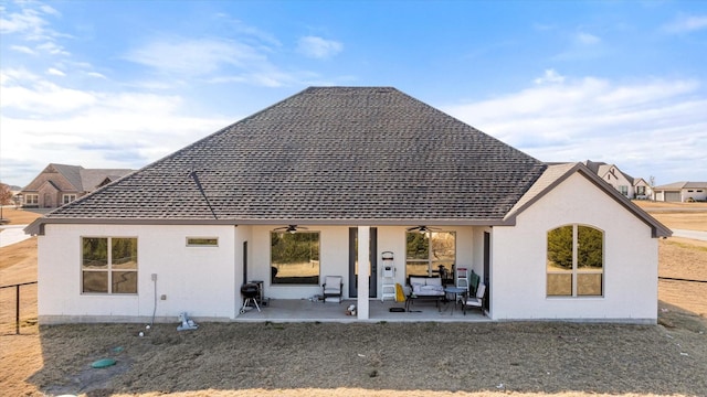 rear view of house featuring an outdoor living space, ceiling fan, and a patio area