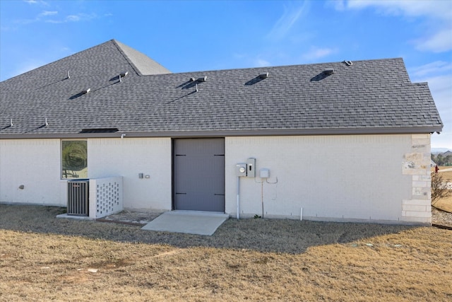 rear view of house with a lawn and central air condition unit