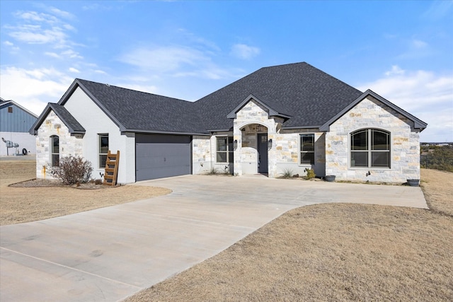 french country style house featuring a garage