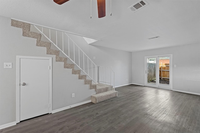 unfurnished living room with dark hardwood / wood-style floors and ceiling fan