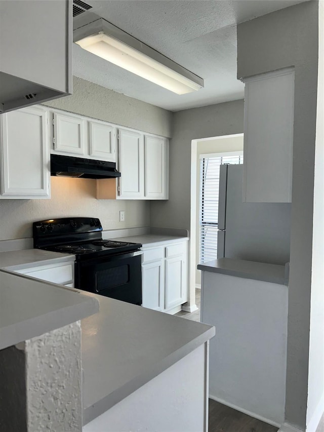 kitchen featuring white refrigerator, white cabinets, dark wood-type flooring, and black range with electric cooktop