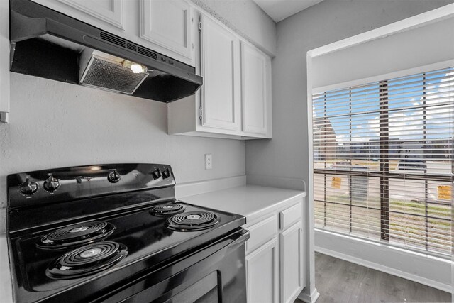 kitchen with dark wood-type flooring, sink, and white cabinetry