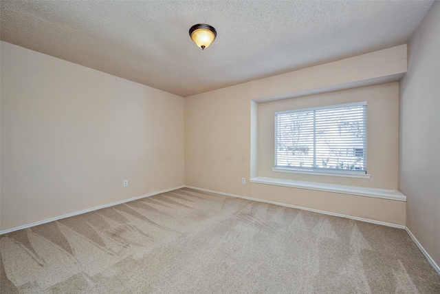 unfurnished room featuring a textured ceiling and light carpet