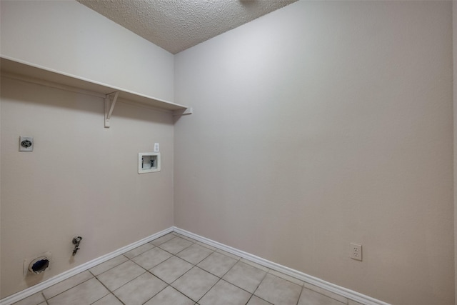 clothes washing area featuring a textured ceiling, hookup for a gas dryer, electric dryer hookup, washer hookup, and light tile patterned floors