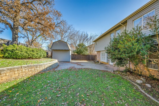 view of yard with a patio area and a storage shed