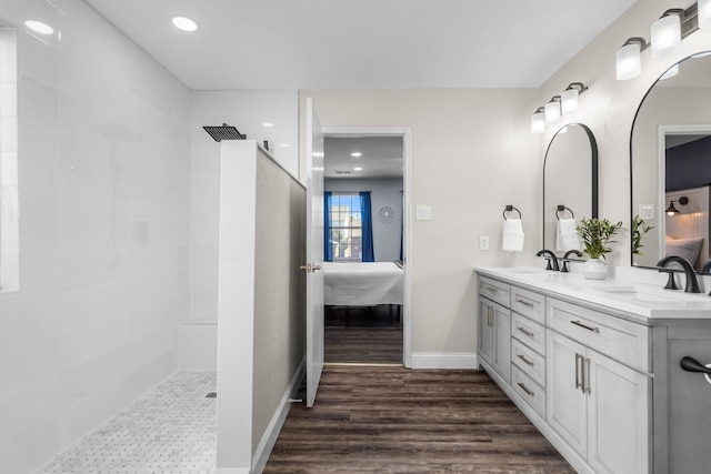 bathroom with a shower, wood-type flooring, and vanity