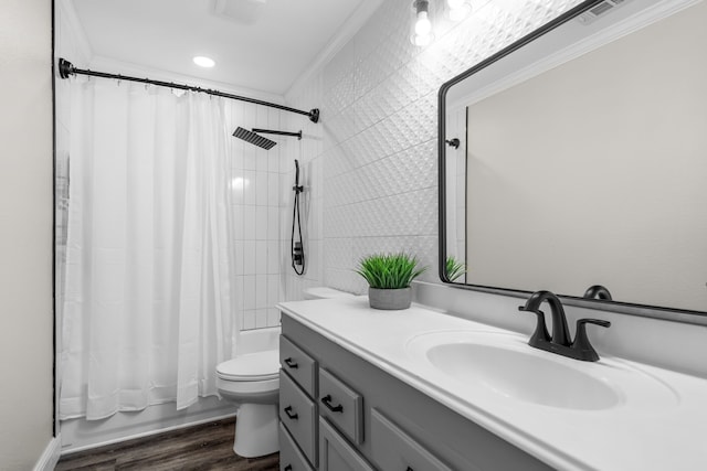 full bathroom with toilet, hardwood / wood-style floors, crown molding, vanity, and shower / bathtub combination with curtain