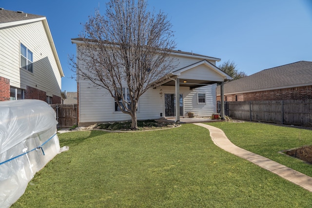 back of house featuring a yard