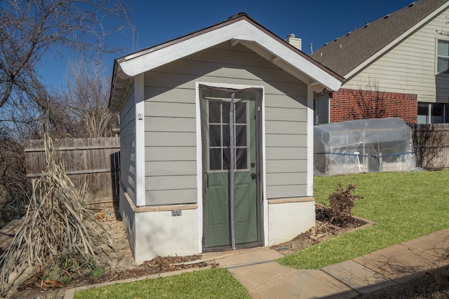 view of outdoor structure featuring a lawn