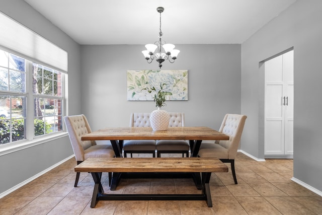 dining space with an inviting chandelier and light tile patterned floors