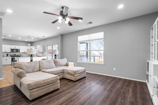 living room featuring ceiling fan and wood-type flooring